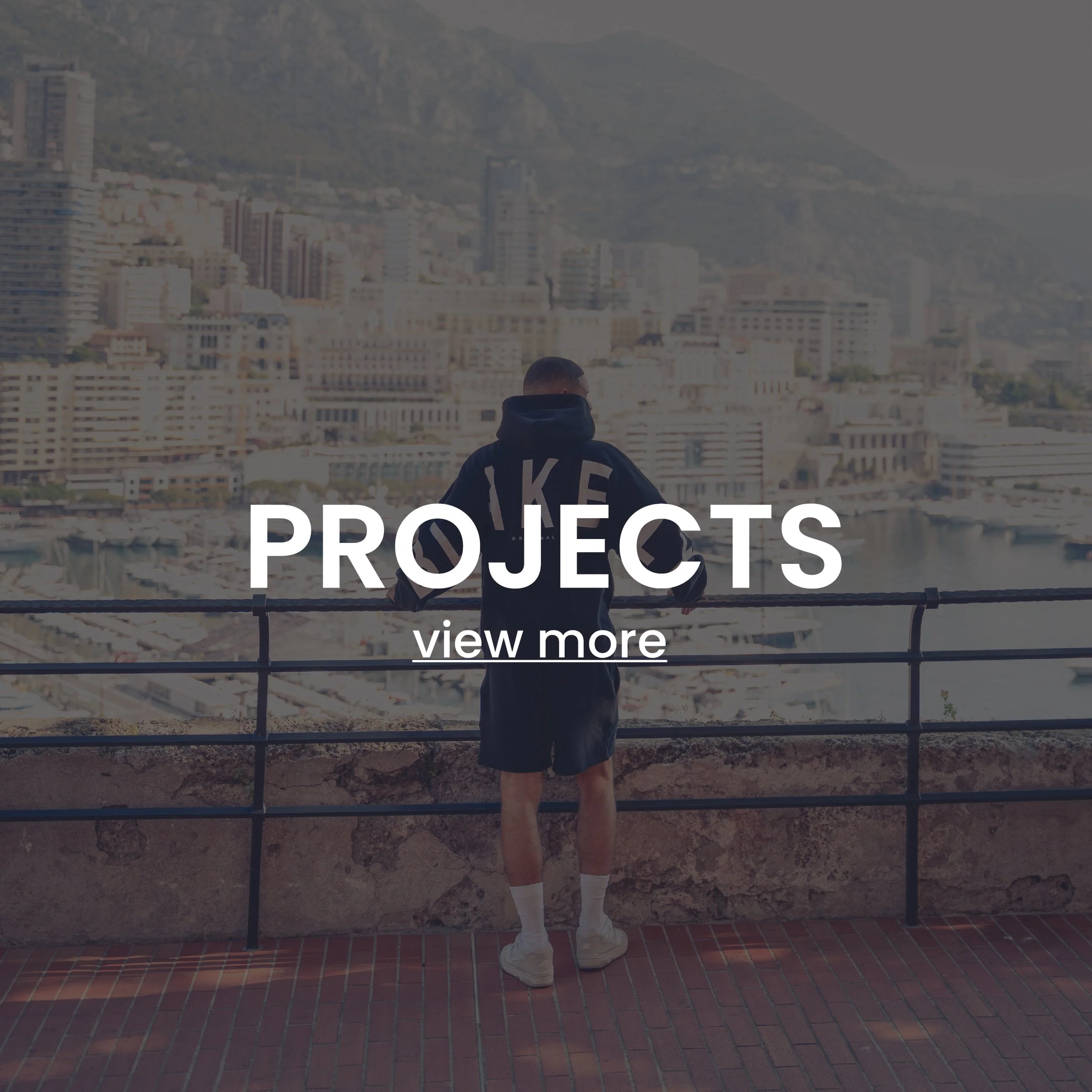 Person in sports attire overlooking a cityscape from a terrace with text 'PROJECTS view more' overlaying the image.