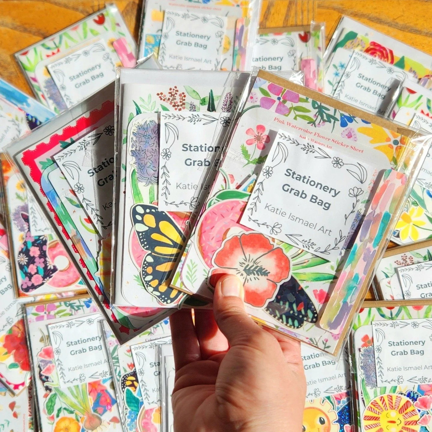I'm having a grab bag sale to get rid of my Katie Watters Art merchandise and celebrate my name change to Katie Ismael Art 🎉🎉
Each stationery grab bag has two greeting cards, 2 sticker sheets, 5 waterproof stickers, and one new surprise item! All f