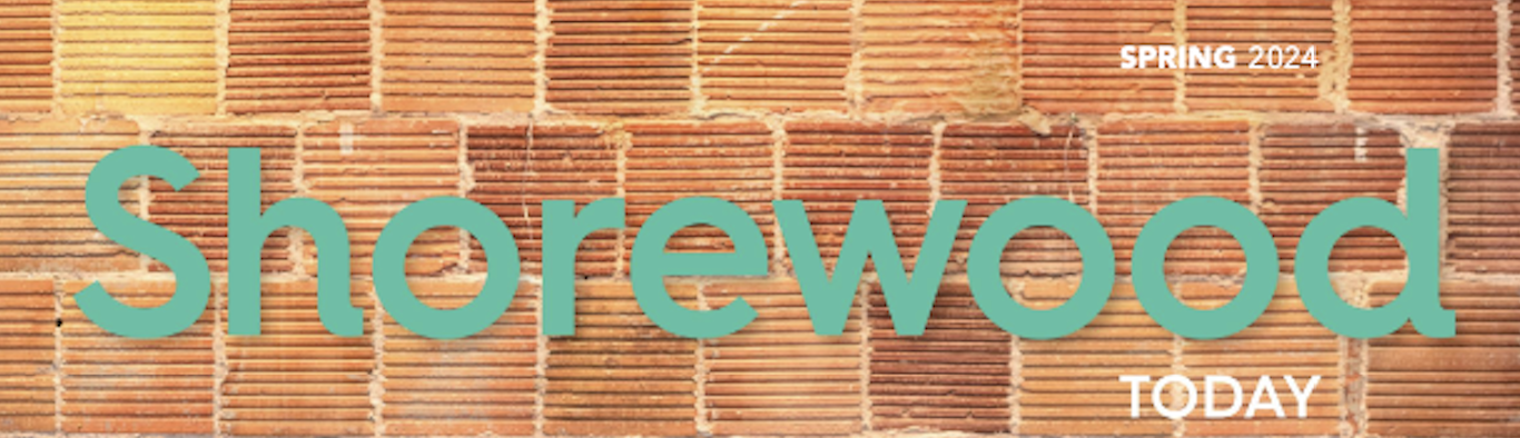 Shorewood today Spring 2024 Magazine. Green letters and red/orange brick background
