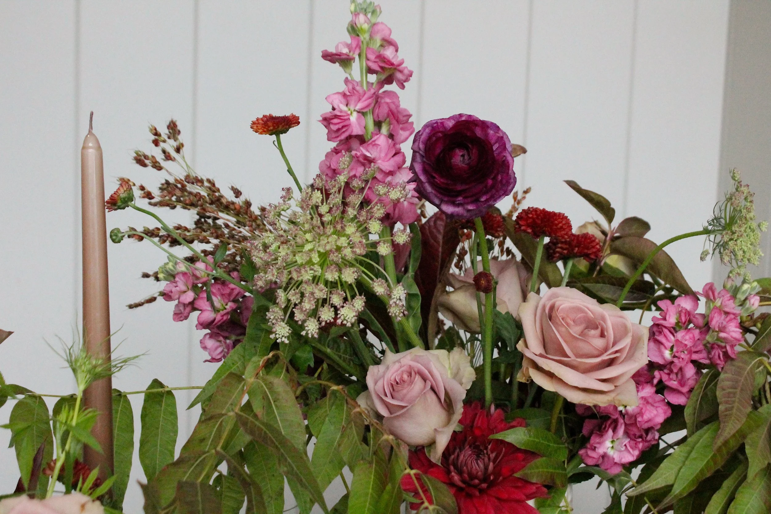 Close up of the moody Thanksgiving centerpiece in mauve, magenta and deep plum