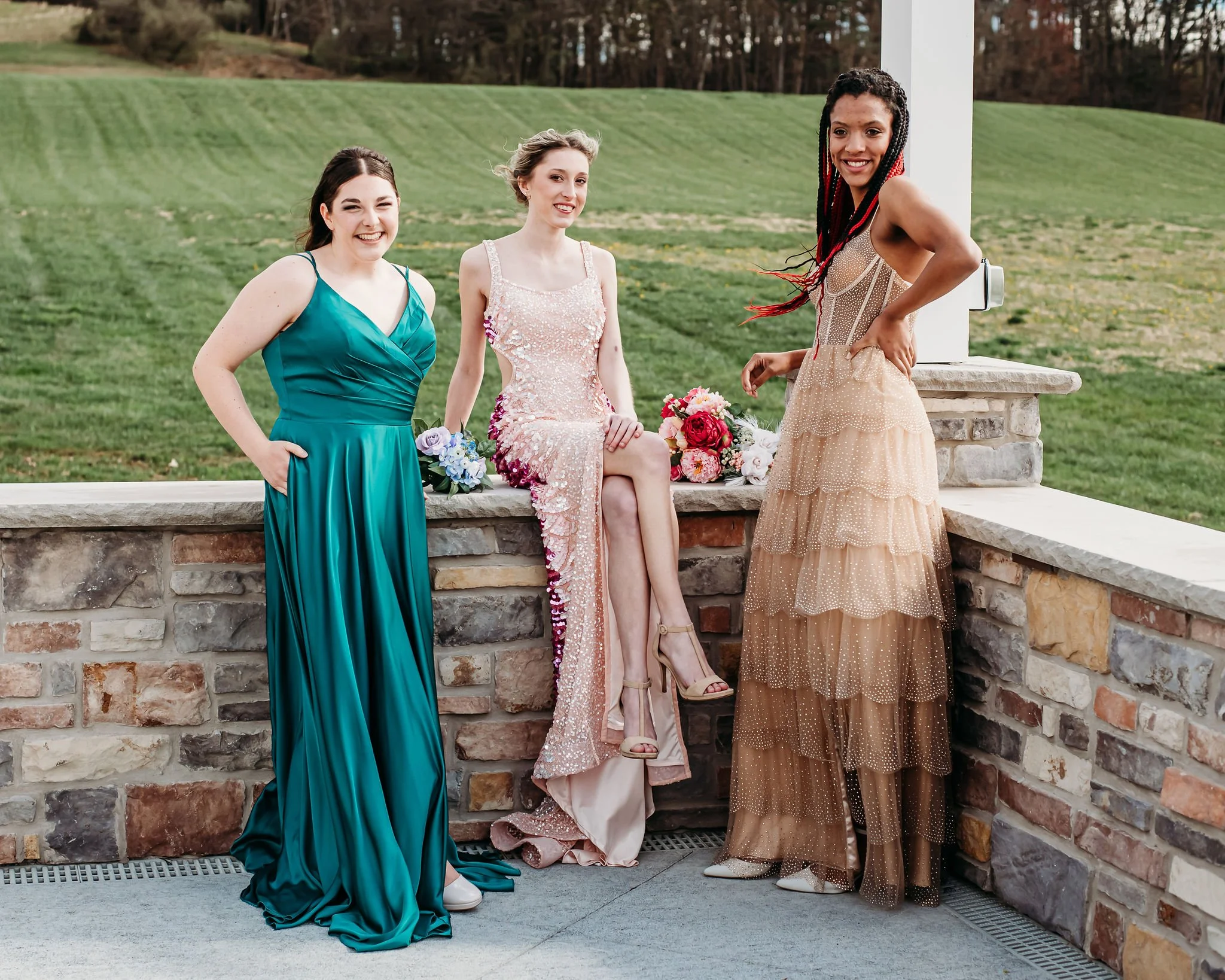 Three high school girls in prom dresses
