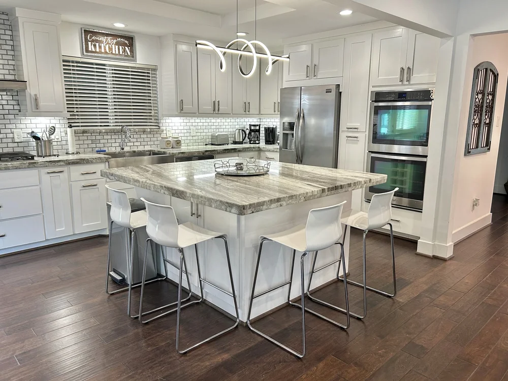 Open kitchen with island seating at Venetia Grove, a five bedroom furnished house in Meyerland, Houston
