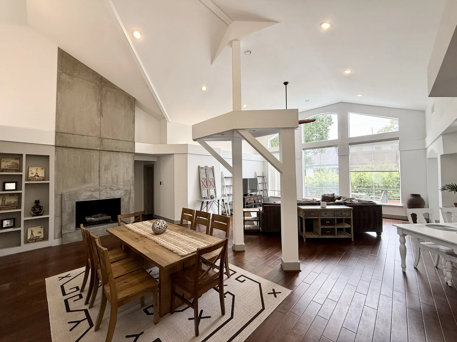Open living and dining room with vaulted ceilings at a furnished Luxurway home in Houston