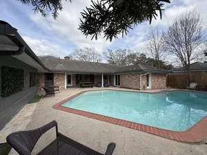 Exterior of Casa Jackie, a four bedroom Luxurway house with a fenced yard for relocating families with pets