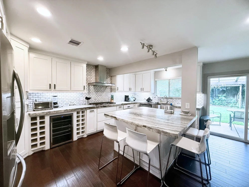 Kitchen at Casa King, a four bedroom Luxurway house in Meyerland, stocked with cookware, dishes and a coffee maker
