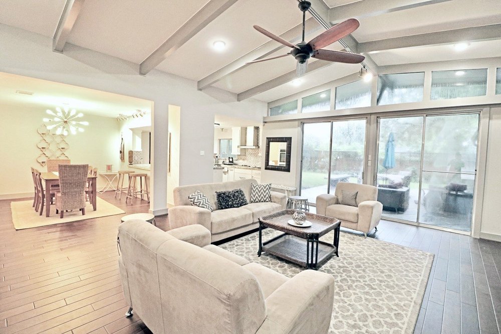 Living room of The New Grove, a four bedroom Luxurway house in Meyerland furnished and ready for a displaced family