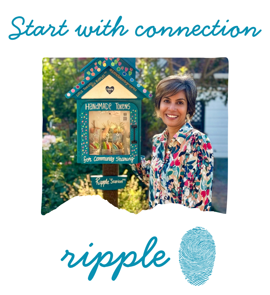 Woman with short hair, wearing a colorful floral shirt, standing outside next to a community sharing handmade tokens collection box called 'Ripple Station'.