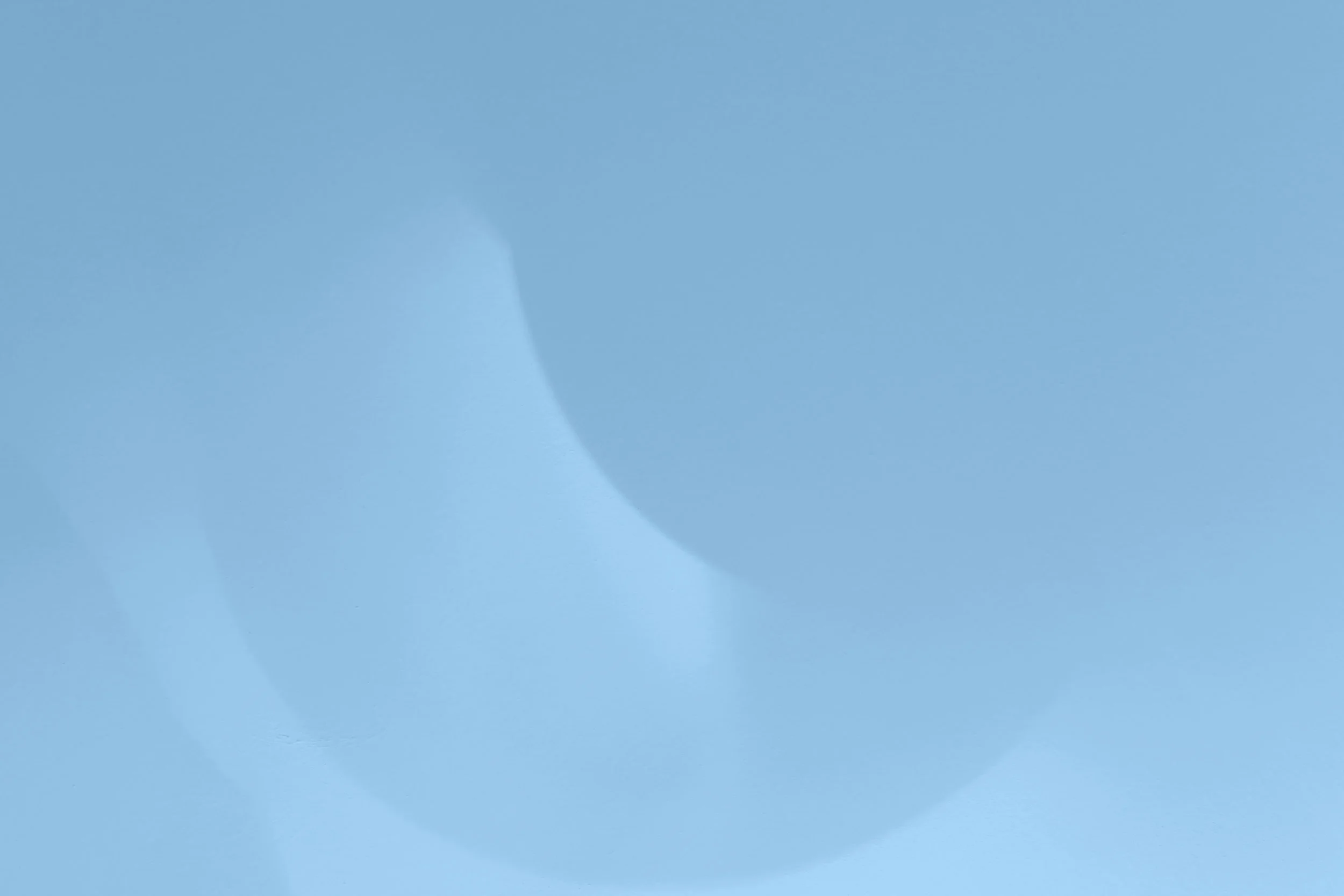 Close-up of a pale blue round-shaped object, possibly a balloon or a sphere.
