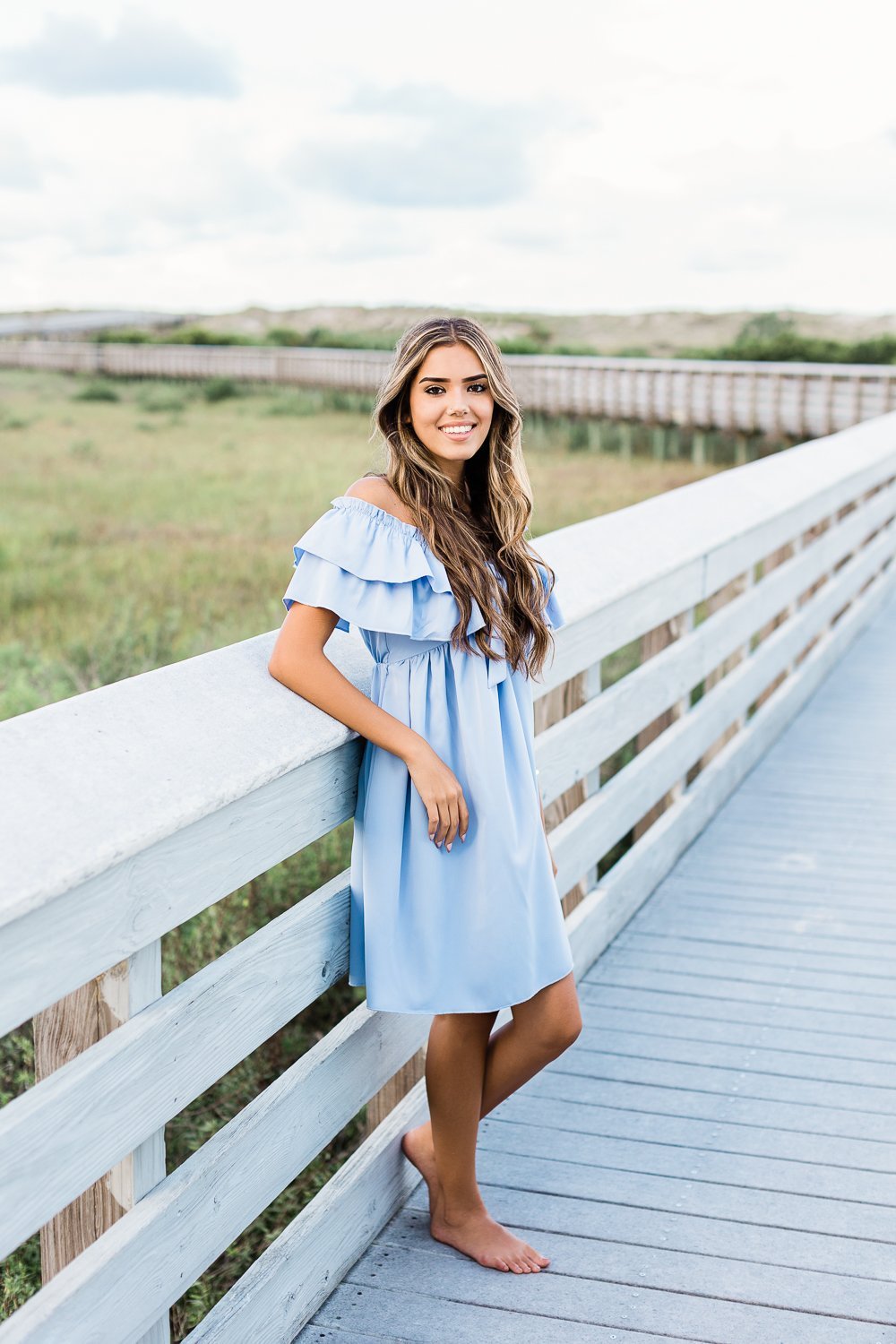 senior pictures on the boardwalk in Anastasia state park