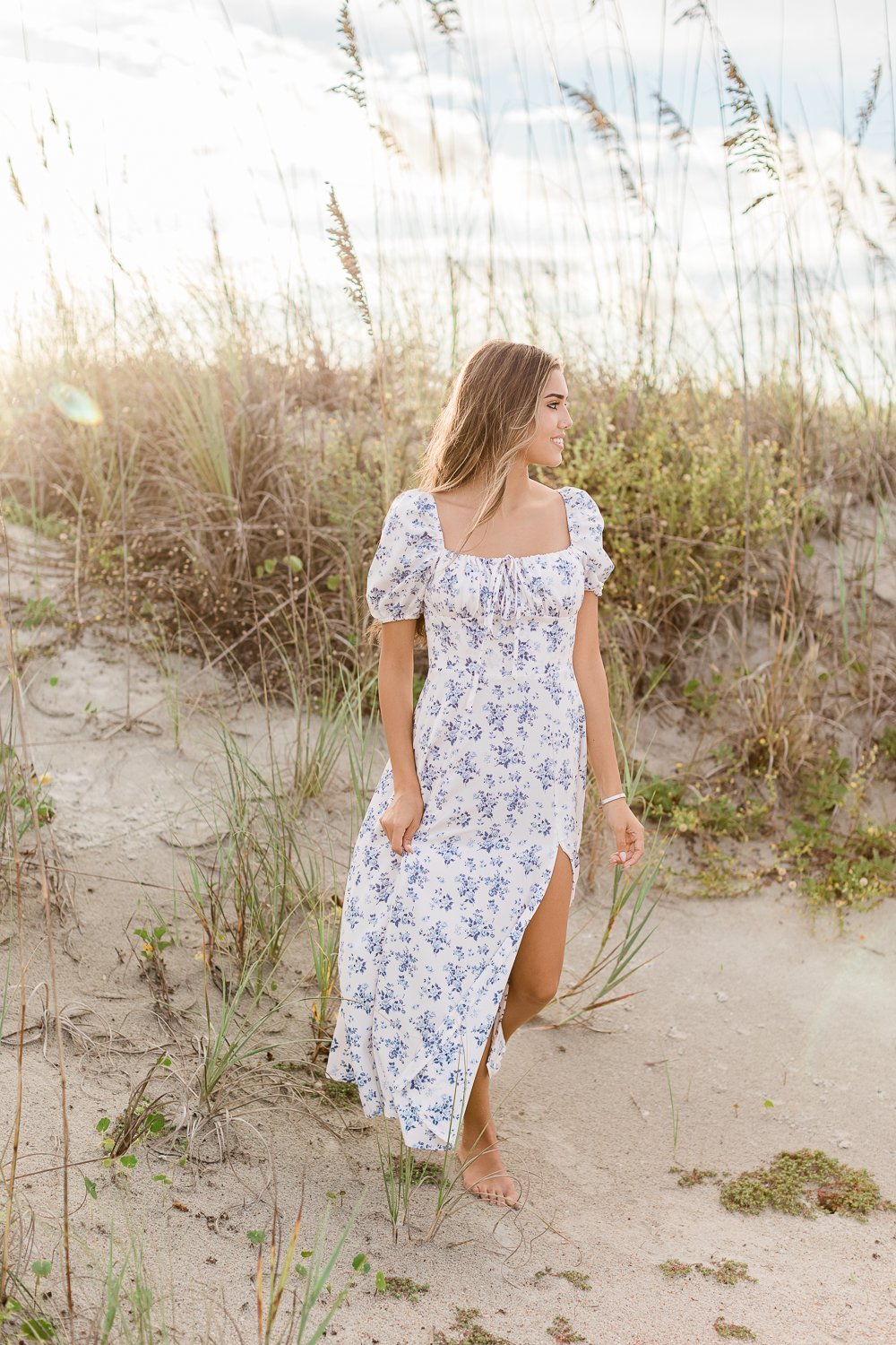 senior photos during sunset with dunes in the background in Anastasia state park
