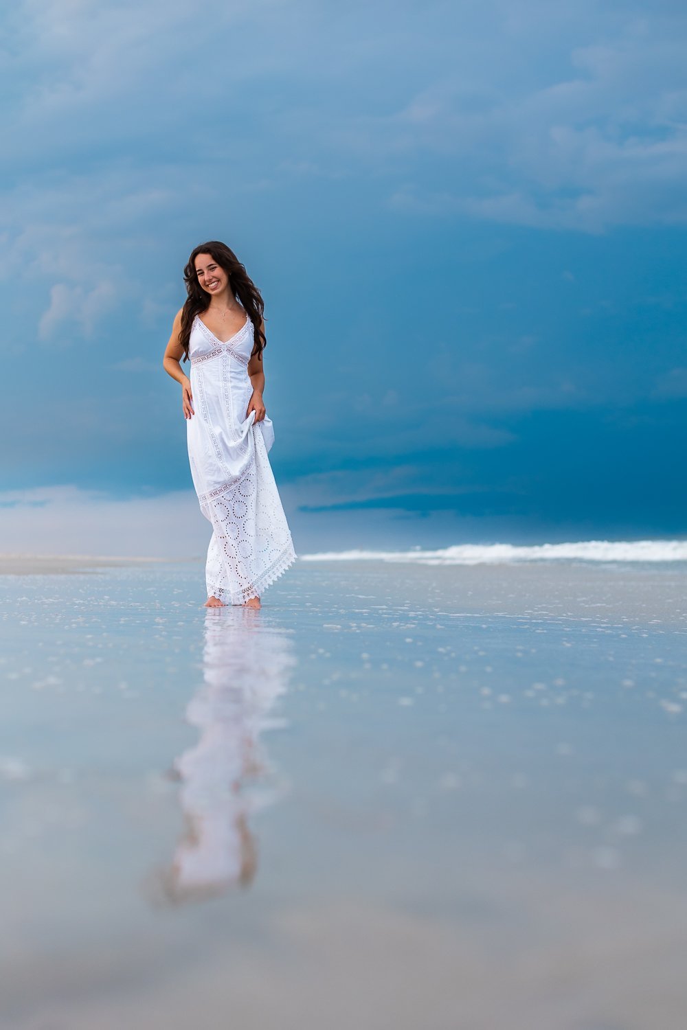 Senior reflection in the water before the storm at the beach in Anastasia State Park