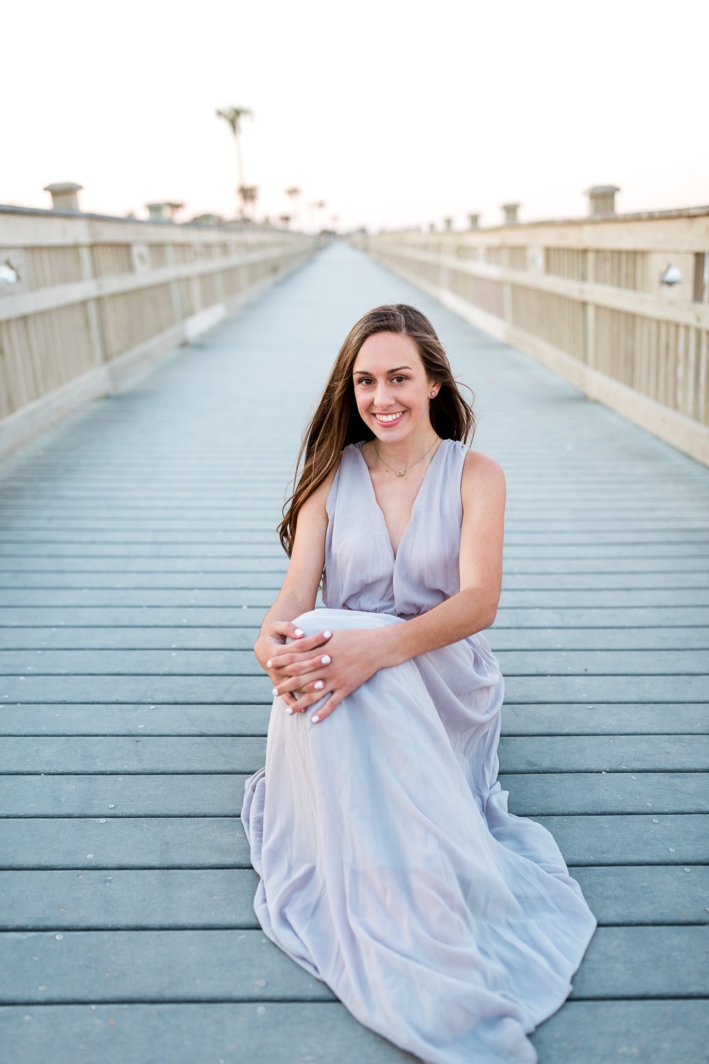 sitting on the boardwalk senior pictures in maxi dress