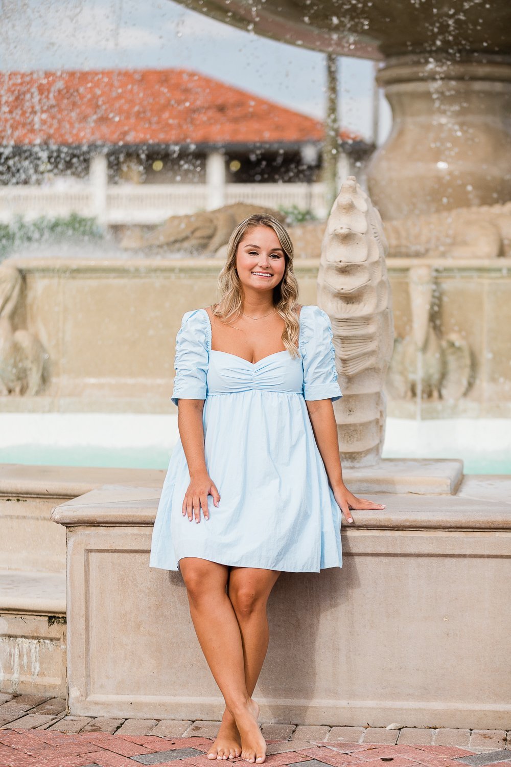 College graduate posing and outfit ideas in front of the fountain in Ponte Vedra Inn &amp; Club