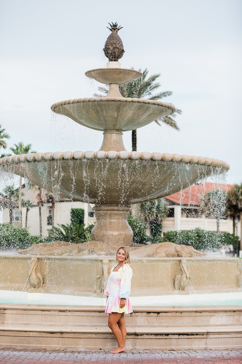 Senior pictures with a stunning backdrop of a water fountain in Ponte Vedra Inn &amp; Club