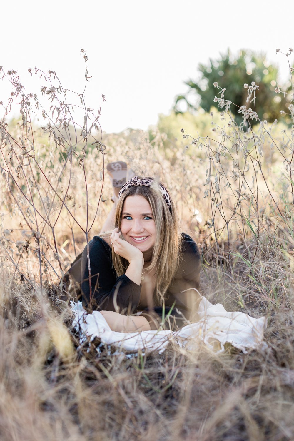Fall senior picture and posing ideas in the grassy field near Ponte Vedra, FL