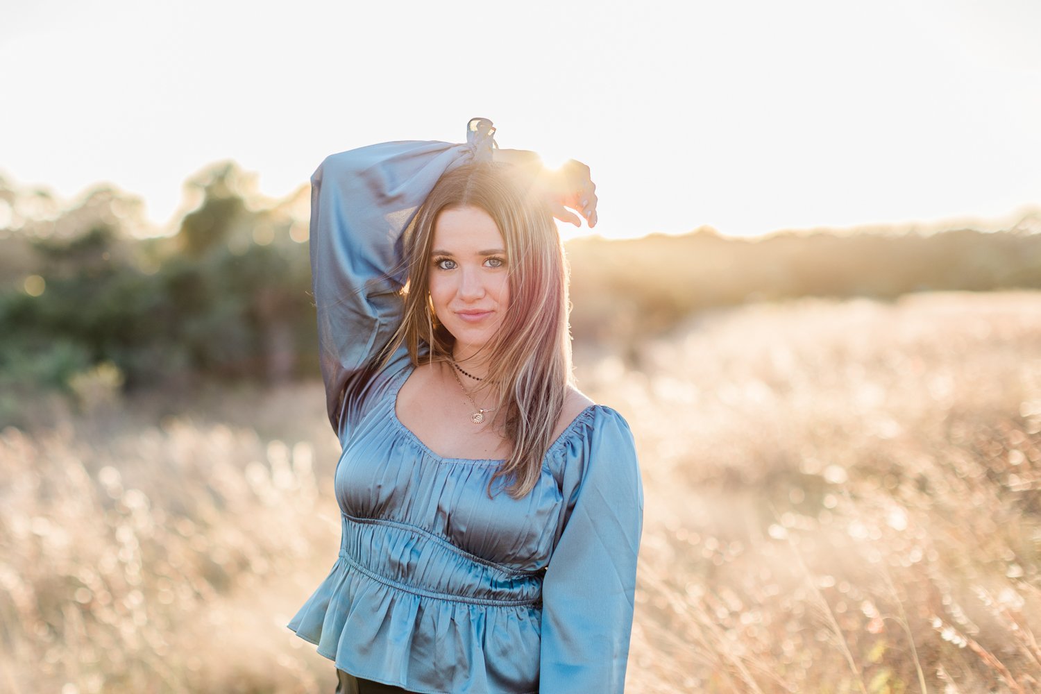 beautiful sunset backlit images of a senior girl in the grassy field near Ponte Vedra, FL