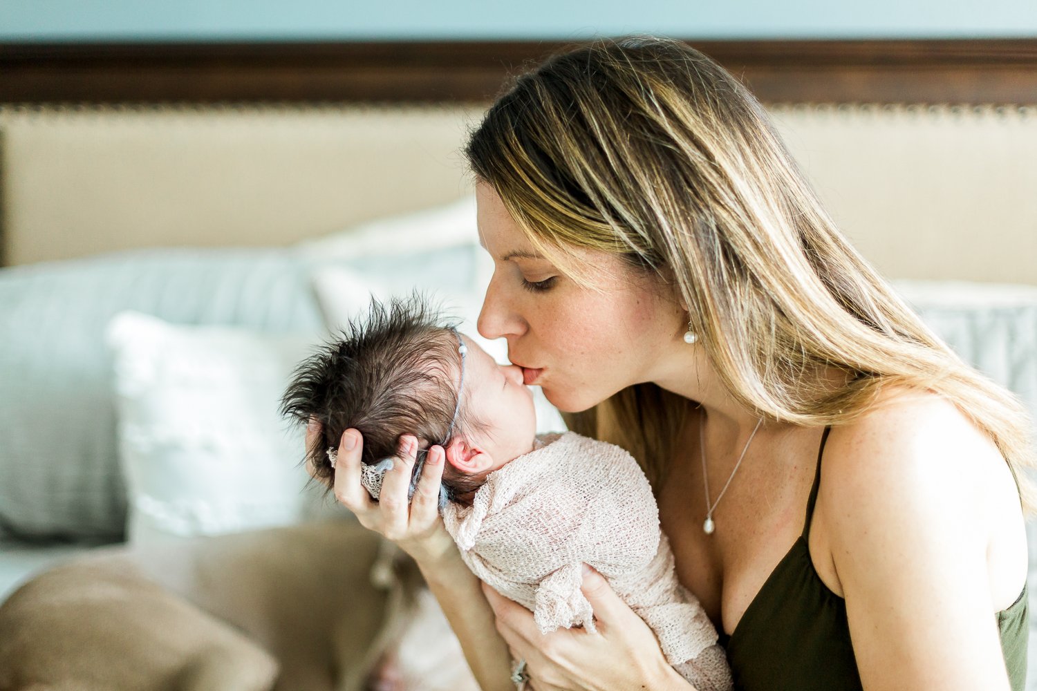 mommy kissing her baby girl during newborn session