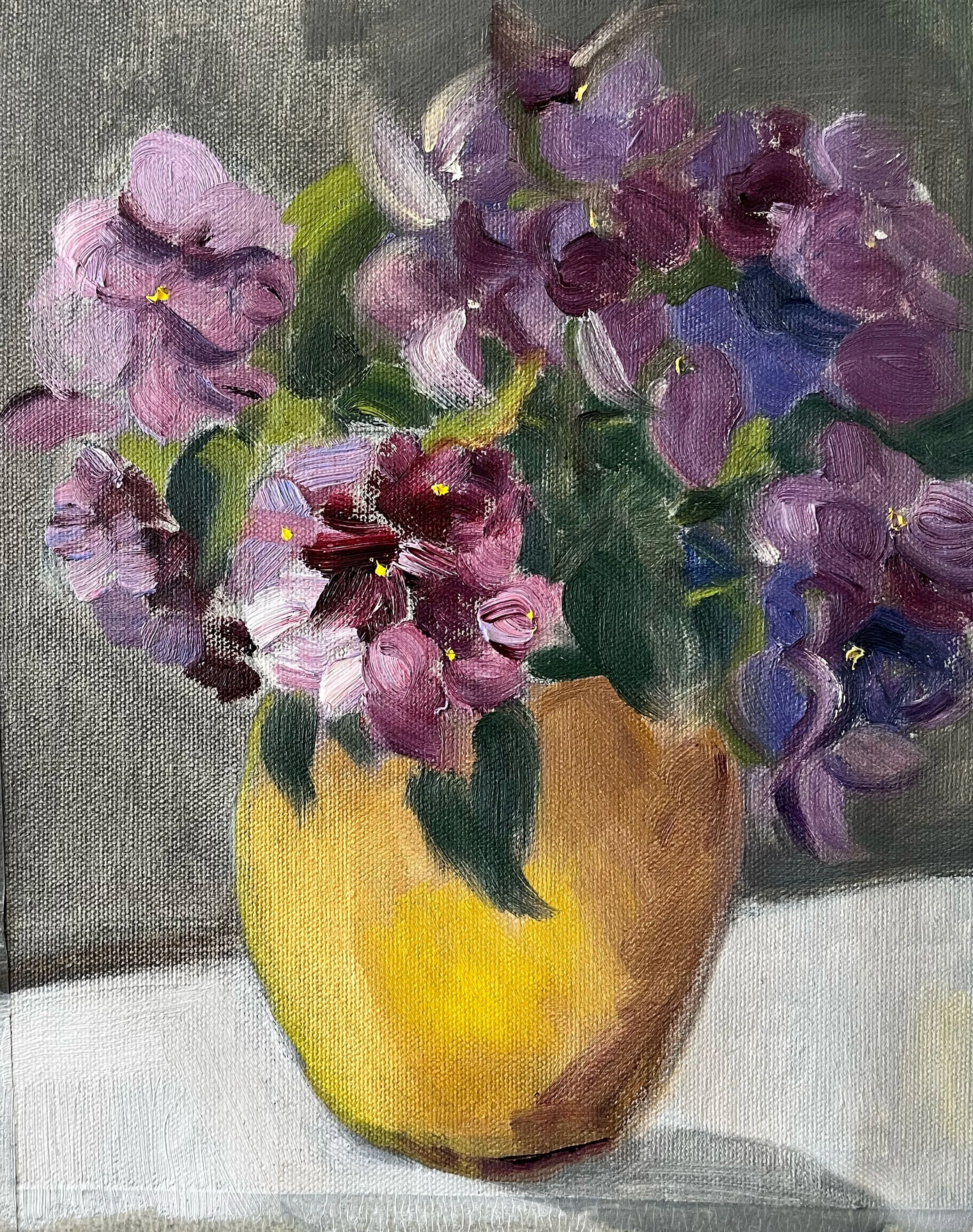 Purple flowers in a yellow vase