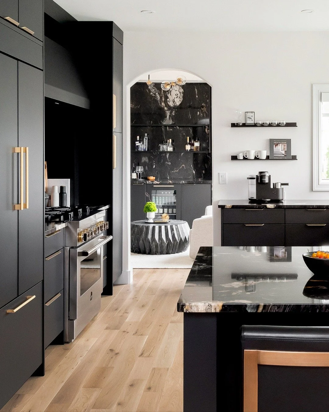 The heart of the home deserves a little drama.

Featuring floor-to-ceiling black cabinetry, striking natural stone, and an oversized island made for gathering, this kitchen is equal parts functional and unforgettable.

Would you ever consider an all 