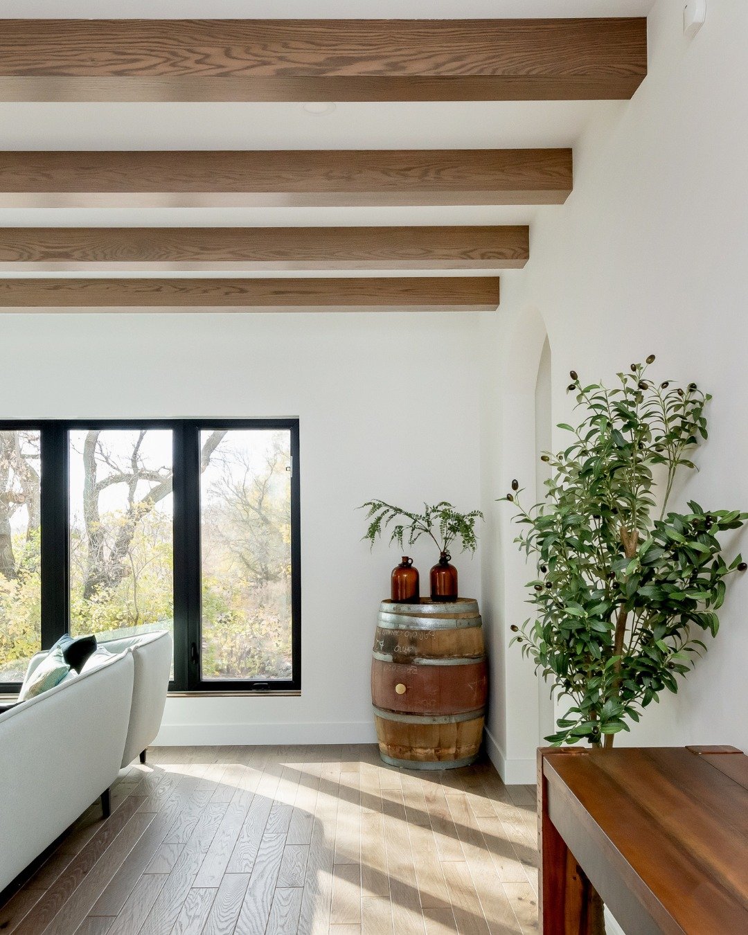 We love how the wood details carry through this home.

From the staircase and floating shelves to the ceiling beams and flooring, you see the same warm tones in different ways throughout the space.

Each space has its own look, but the details keep e