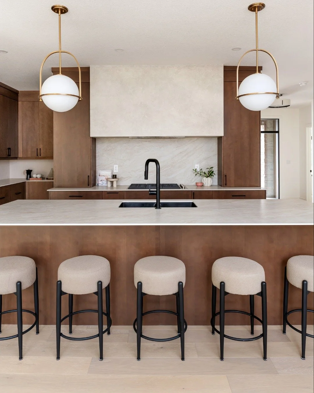A closer look at the kitchen in our most recent build on Lake Crescent.

Warm wood cabinetry, a large island that seats five, soft stone surfaces and those statement pendants come together to create a kitchen that feels both elevated and lived-in.

A