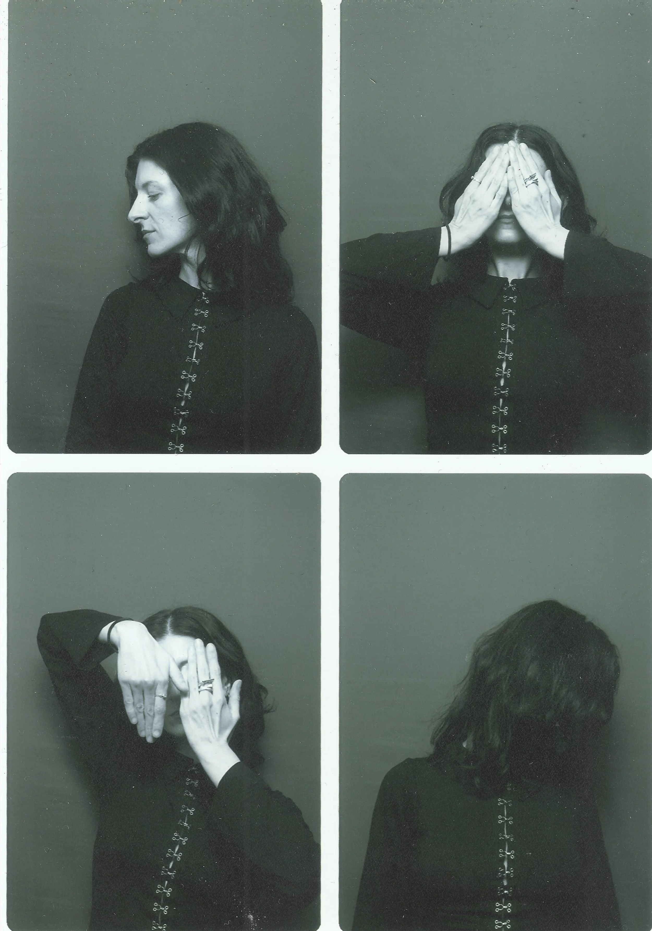 Black and white photo of a young woman with dark hair in four different poses. In the first pose, she is in profile and looking down. In the second, she covers her face with her hands. In the third, she covers her face with her hands again and shows rings on her fingers. In the fourth, she faces away with her eye visible. She is wearing a dark top with decorative buttons down the front.