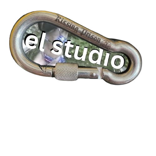 A carabiner clip with the words "el studio" over it, and a photo of a person wearing a face mask in the background.