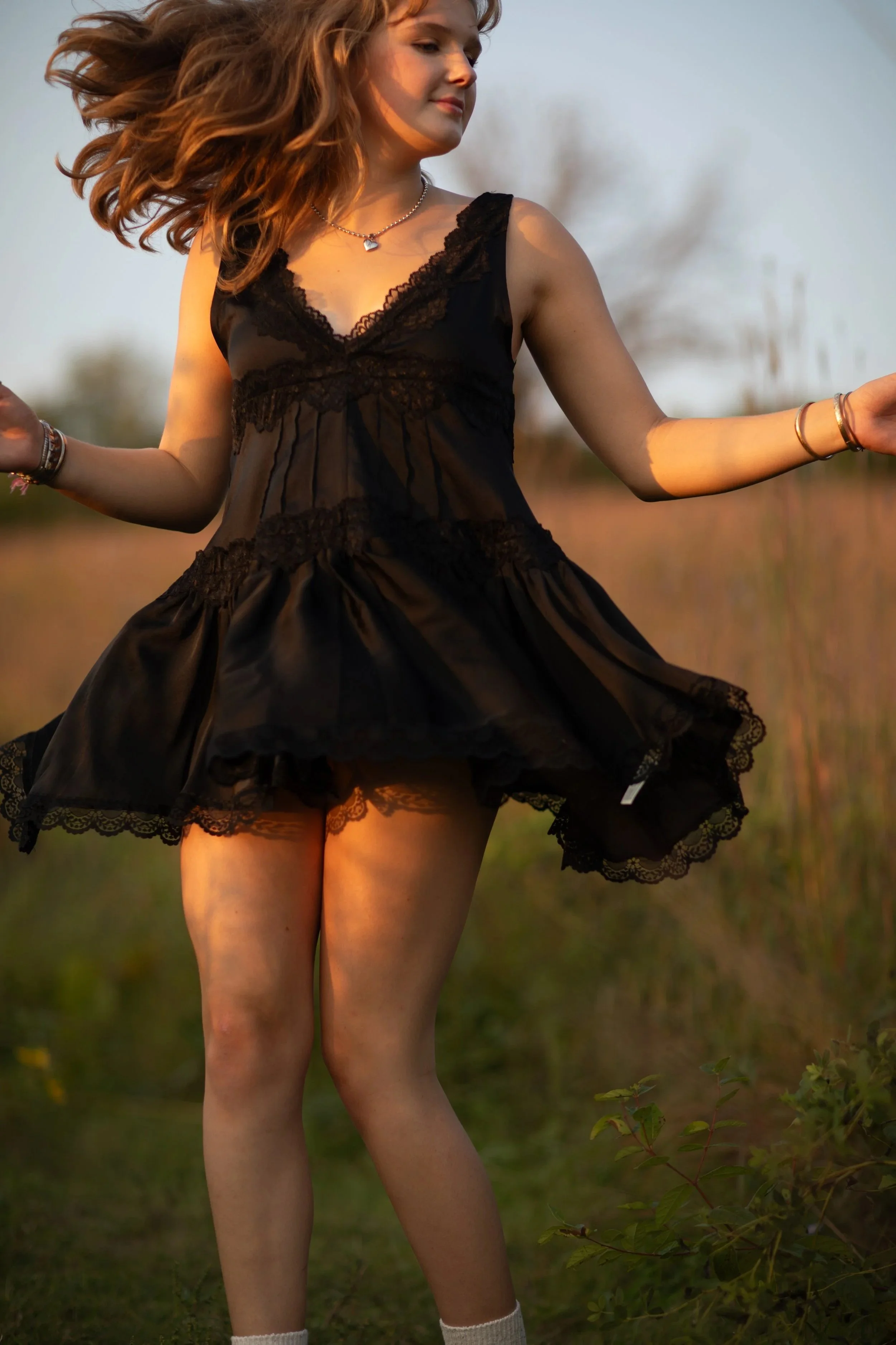 Senior portrait at golden hour in field