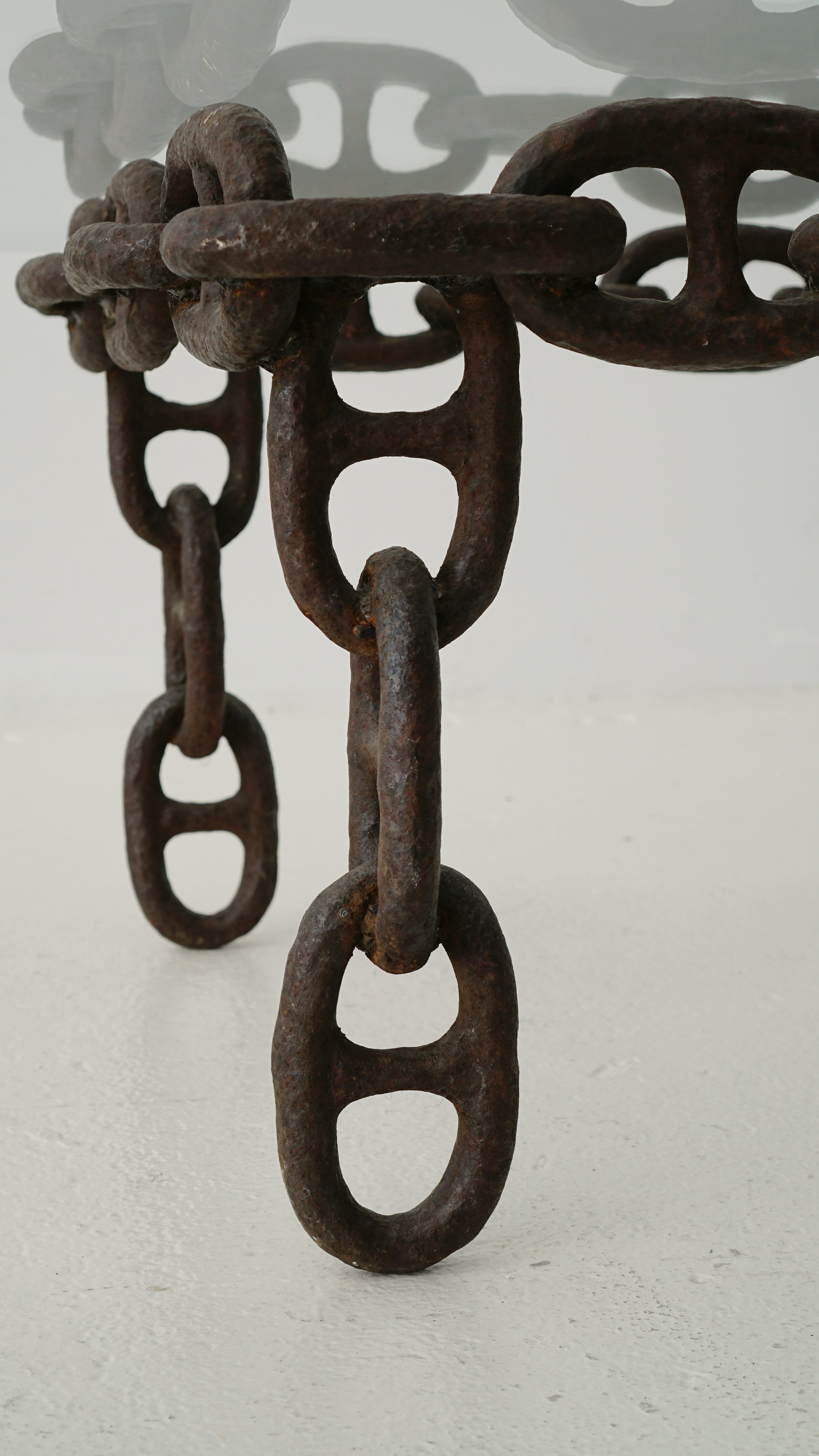 "Industrial chic: coffee table crafted from a decommissioned oil tanker's anchor chain. Rugged yet delicate, it's a captivating blend of history and sophistication.