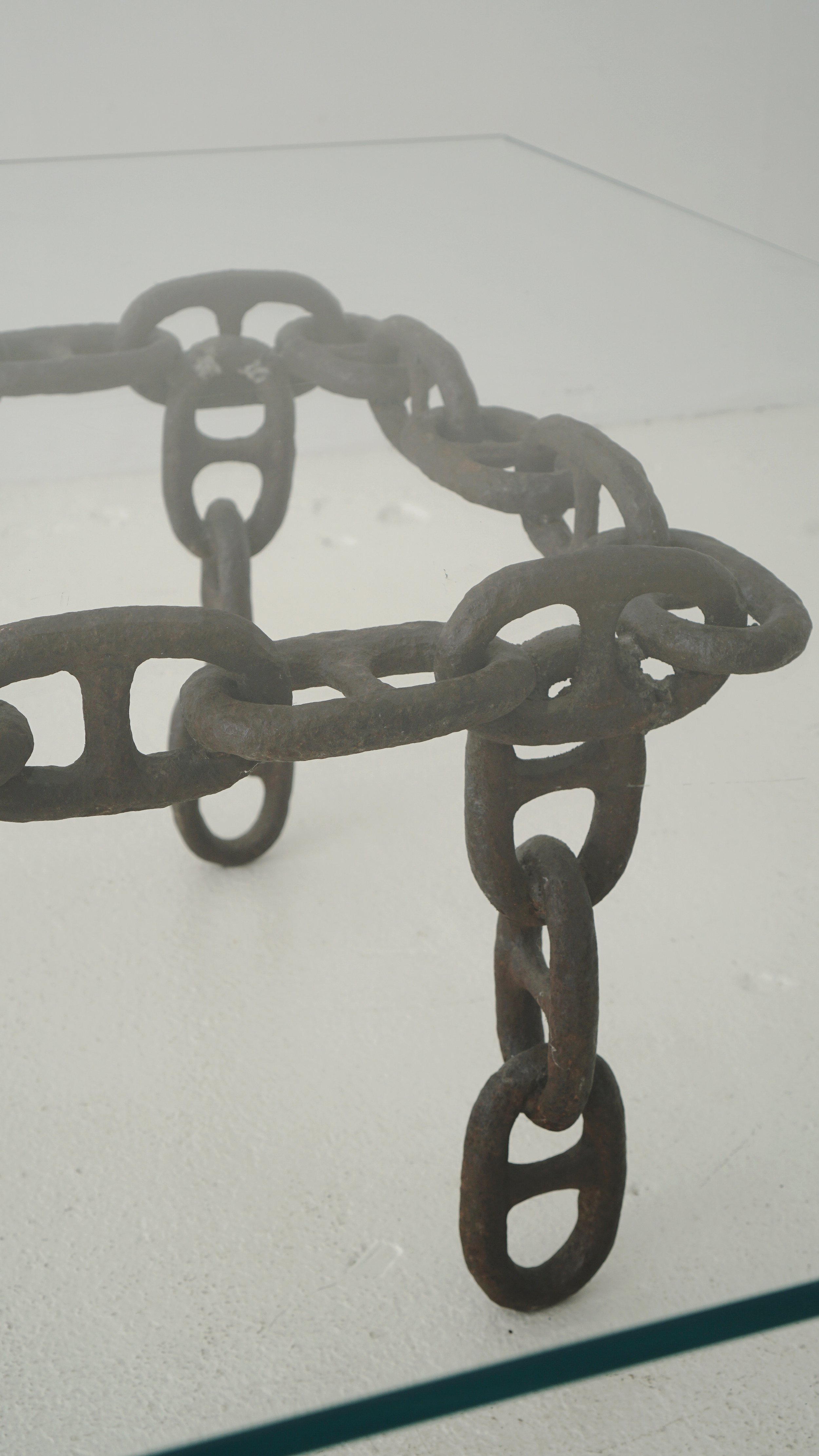 "Industrial chic: coffee table crafted from a decommissioned oil tanker's anchor chain. Rugged yet delicate, it's a captivating blend of history and sophistication.