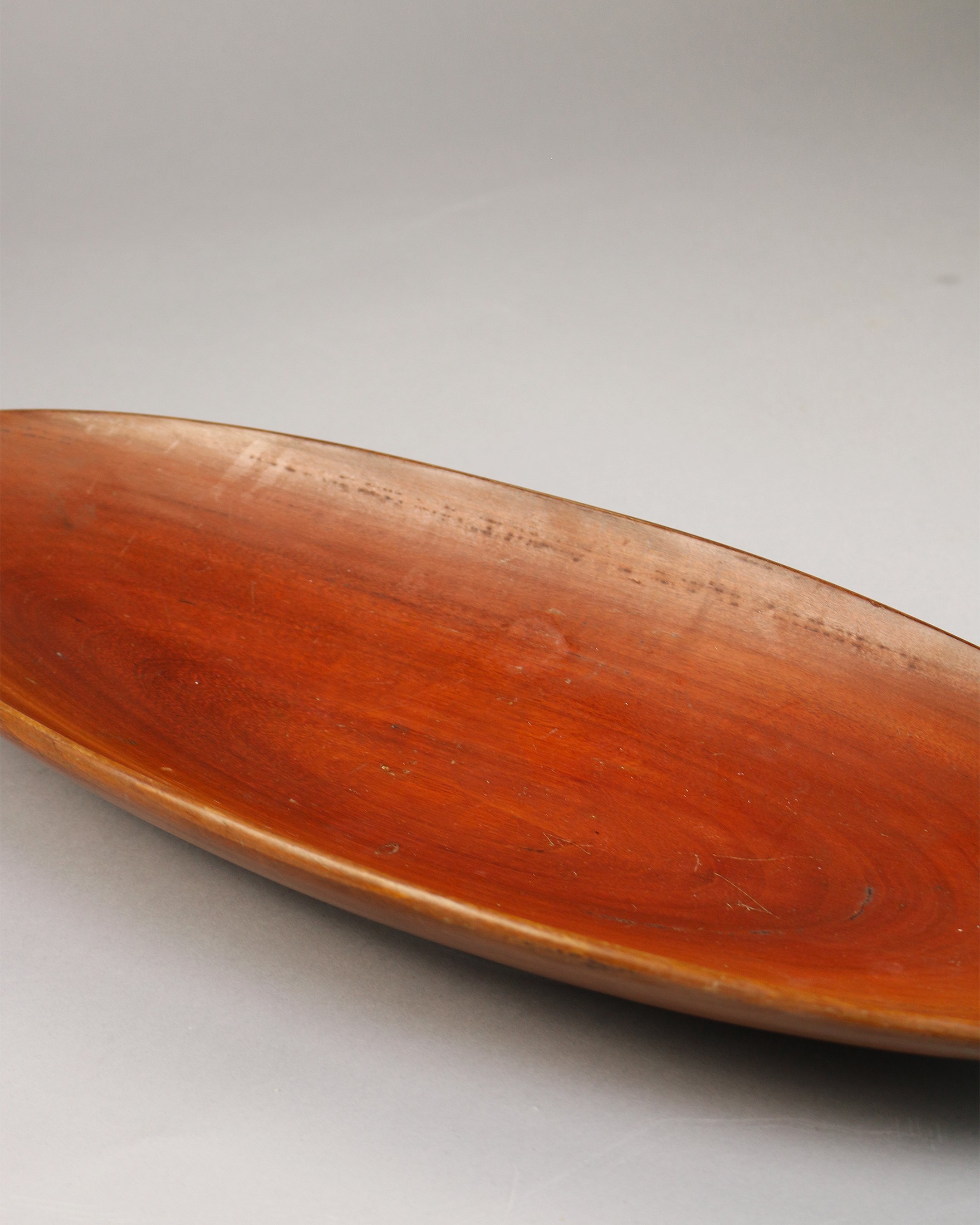 Long 21-inch teak bowl with organic curves, inspired by mid-century Scandinavian craftsmanship.
