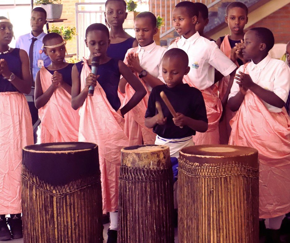 Happy Friday! Bruce, one of our most talented student drummers, is providing a percussion background to a program we are having this morning. Bruce may not look imposing, but he packs a ton of drumming energy into his small frame.

The drum is Rwanda