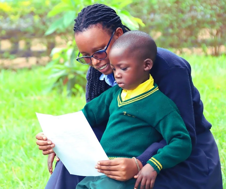 Devotha Mutuyemariya, our Sponsorship Coordinator, is reading a letter from their sponsor to one of our children. Our children absolutely love receiving letters from their sponsors!

We appreciate all our sponsors who regularly write letters to their