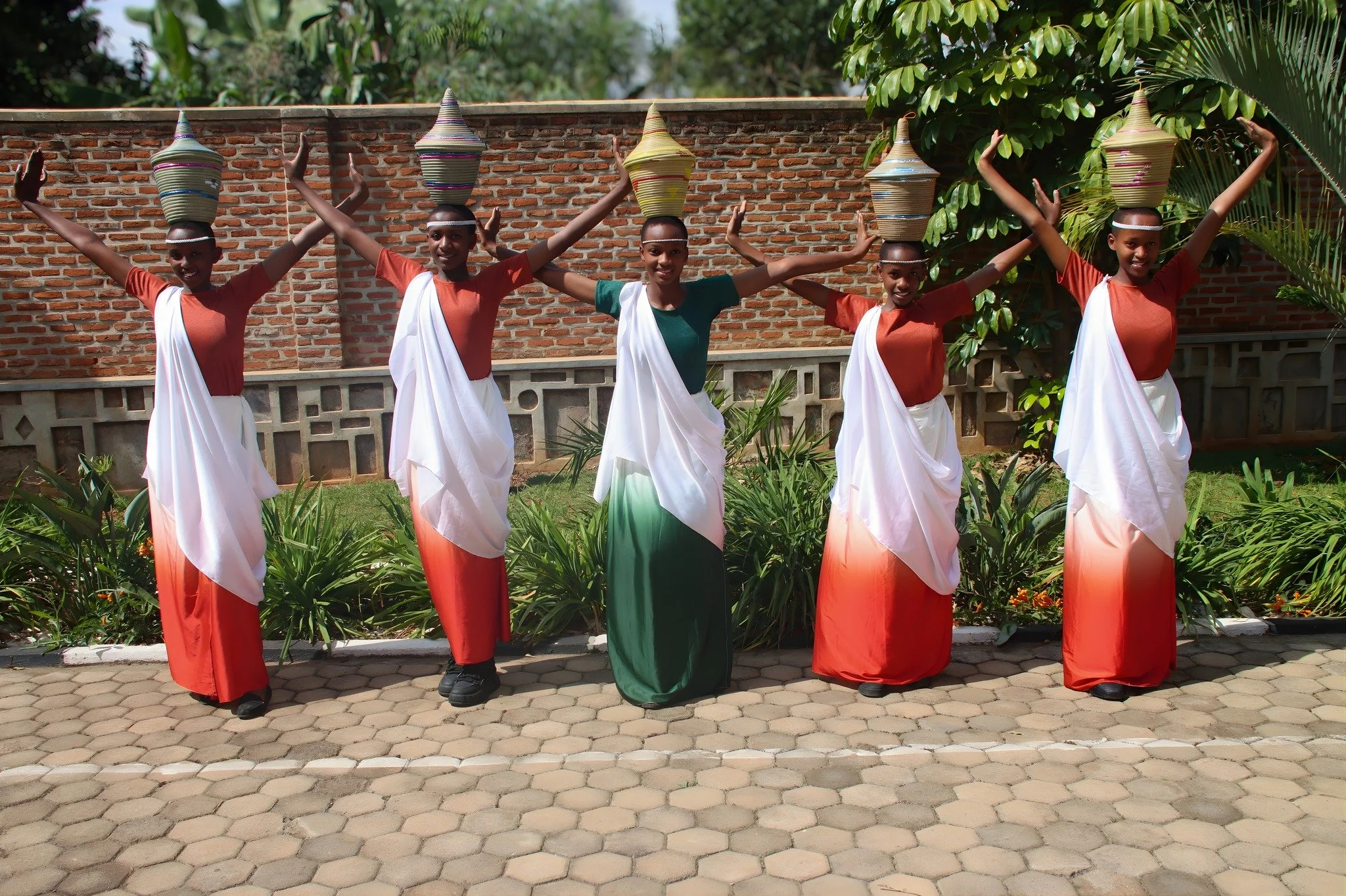 Members of the RCCS traditional dance troupe are performing the Umushayayo, also known as the Dance of Women. This traditional Rwandan dance showcases women dancing with baskets. The dancers use the iconic Agaseke, or peace basket, to symbolize peace