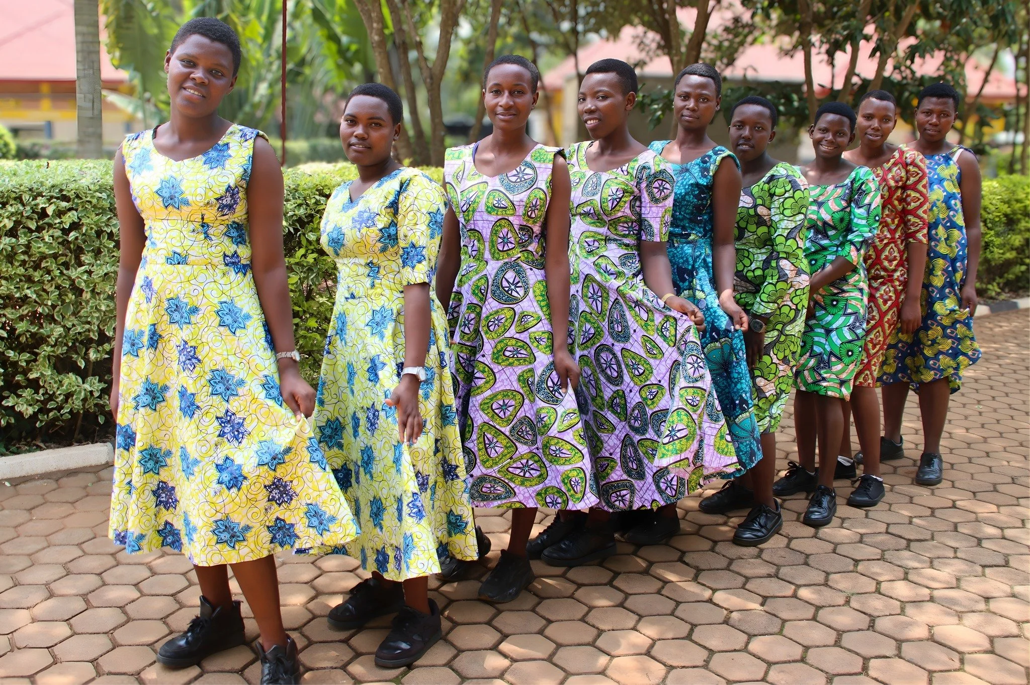 Join us for a Rwandan fashion show as several of our sewing training students model their latest creations. The vibrant colors of the fabrics highlight the students' stylish designs. Not only are these young women learning a valuable skill, but they 