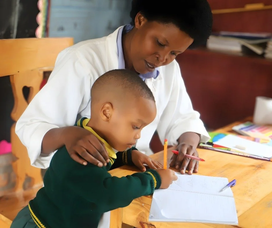 Gabriella grips her pencil tightly, concentrating on every letter.

Not long ago, she didn&rsquo;t know how to write her name.

RCCS teacher Angelique Uwizeyimana leans in beside Gabriella, offering gentle guidance as she practices her writing&mdash;