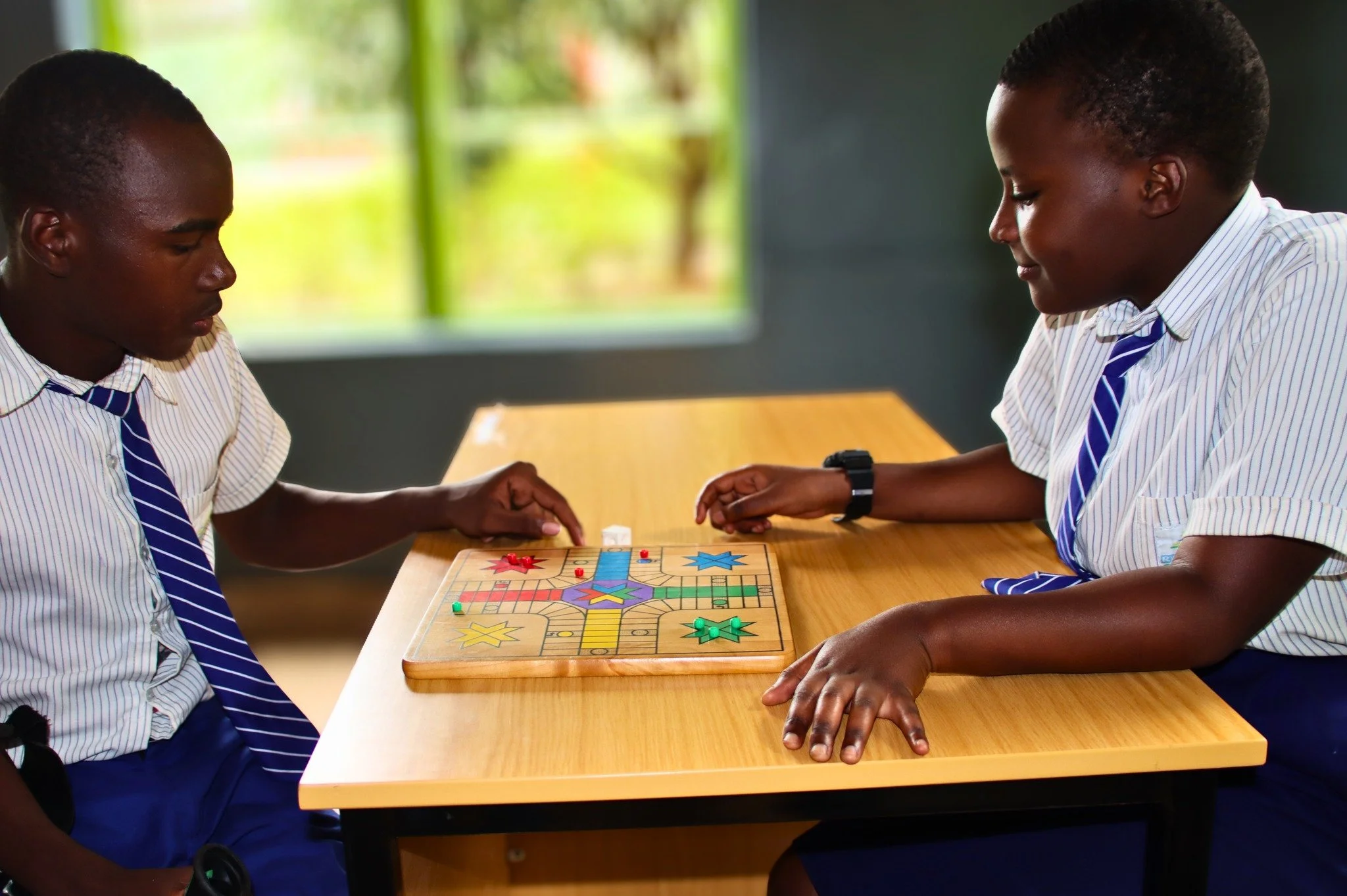 Learning doesn&rsquo;t only happen from books.

Jean Baptiste and Nuda are deep in a game of Ludo&mdash;thinking ahead, making decisions, and enjoying the challenge together.

These moments build more than knowledge. They shape patience, strategy, an