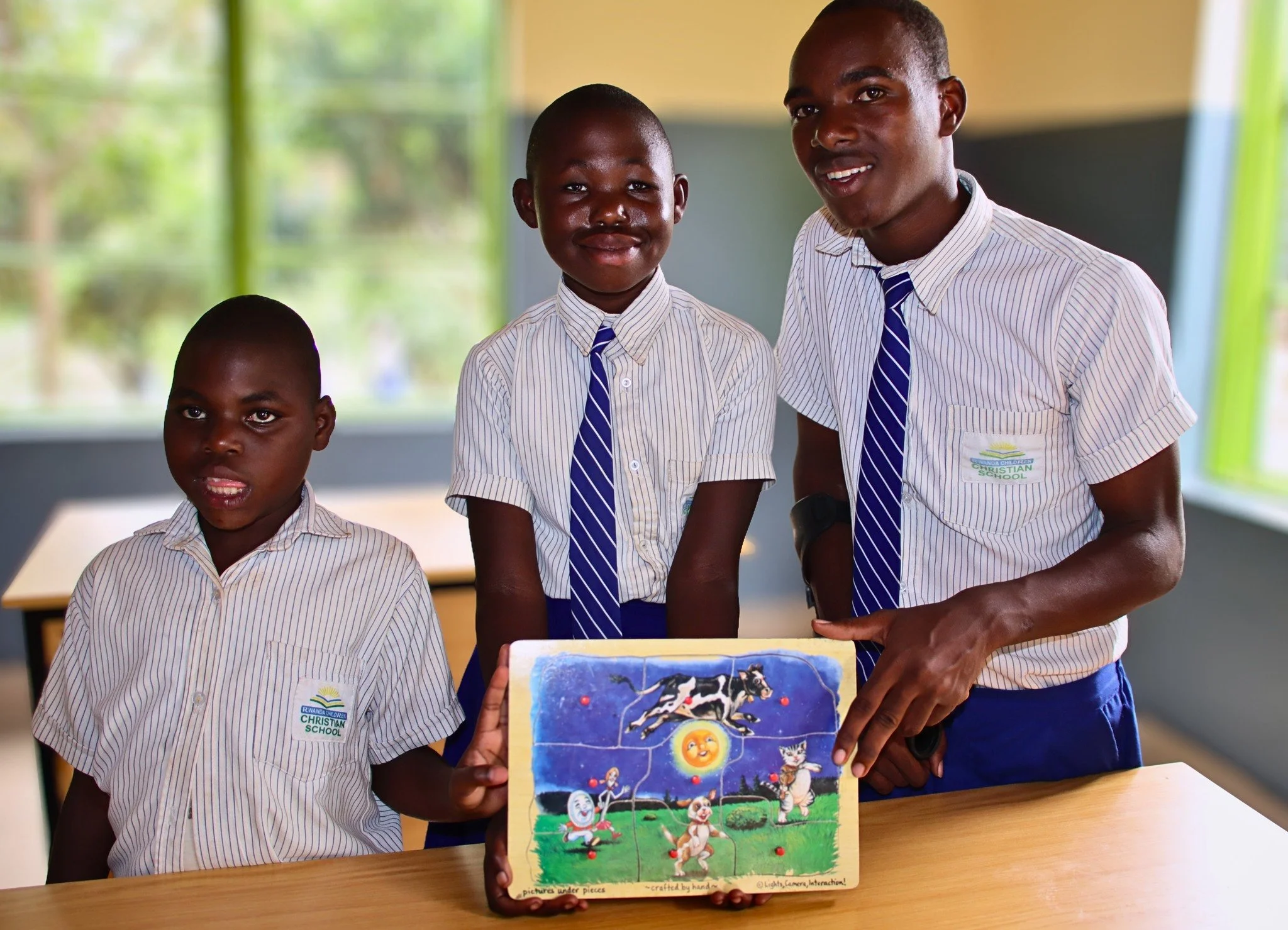 Working together.

Nicole, Alliane, and Jean Baptiste proudly show the puzzle they completed&mdash;each piece a reminder of what can happen when children are supported, included, and encouraged.

Each of these children learns and grows in their own w