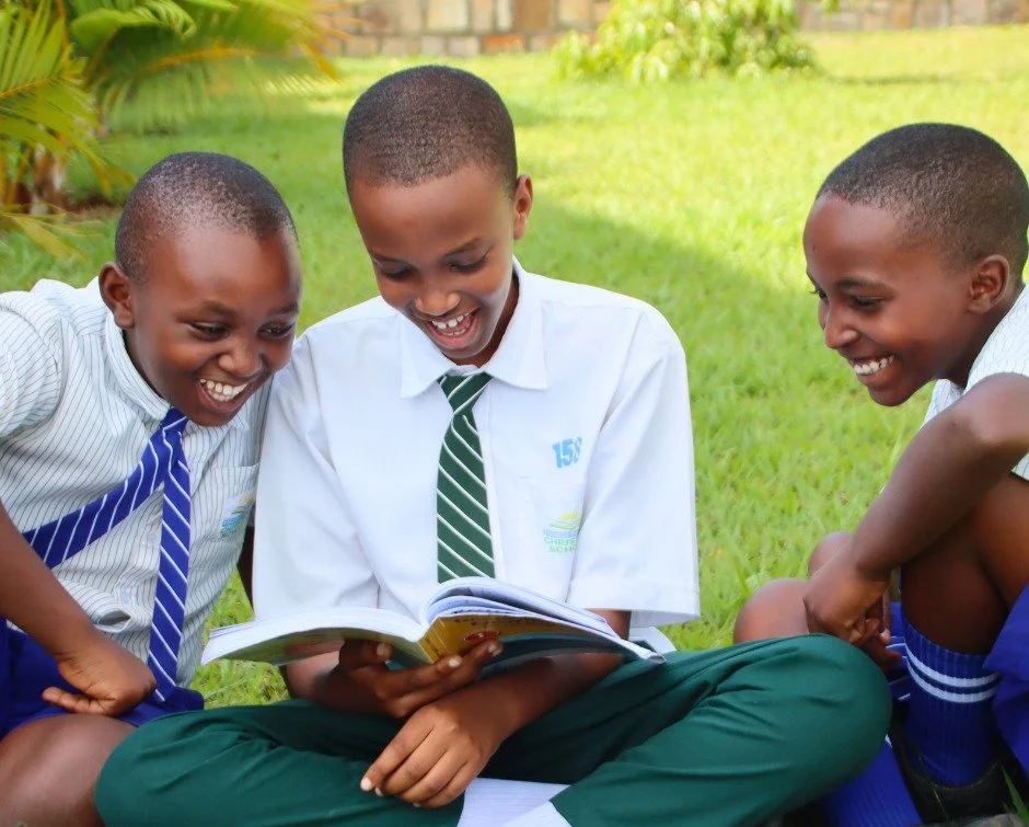 Aldon, Marc, and Tunga sat down together on the grass with a book &mdash; and something happened that books always seem to produce: laughter.

Whatever they found on that page, they found together. And they could not stop smiling.

For just $15, you 