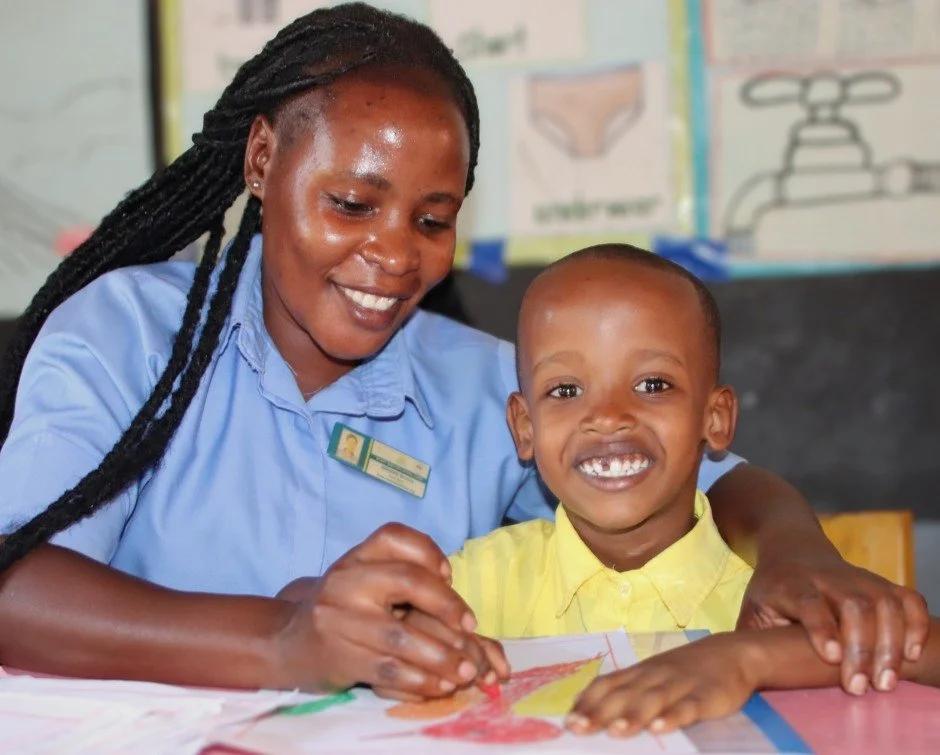 RCCS teacher Monica Birungi placed a gentle hand on Jaydan&rsquo;s shoulder while he worked on a drawing.

Jaydan is four years old. He loves swimming and dreams of becoming a pilot someday.

In that moment &mdash; a hand on a shoulder, a crayon on p