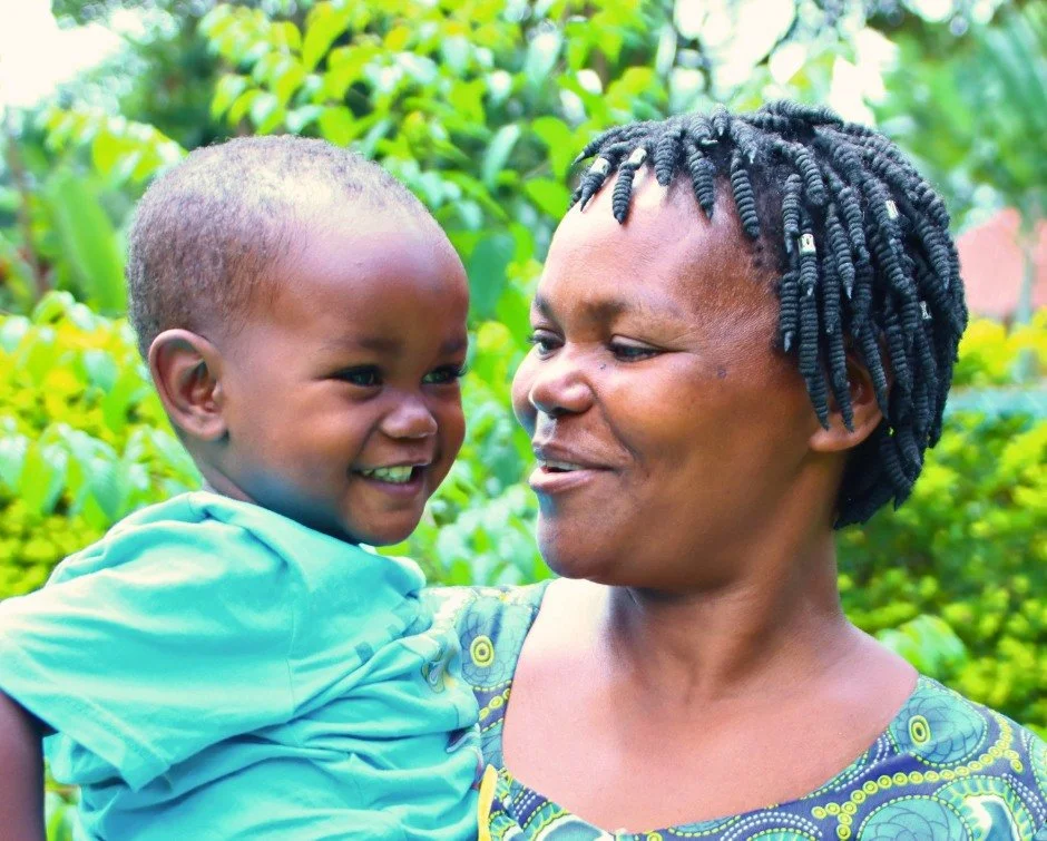 Every day on this campus, stories like Arnold's unfold.

Rachel sits at our health center holding her grandson. Arnold is two and a half years old.

He was not always this strong.

Arnold entered our program facing significant health challenges. Toda