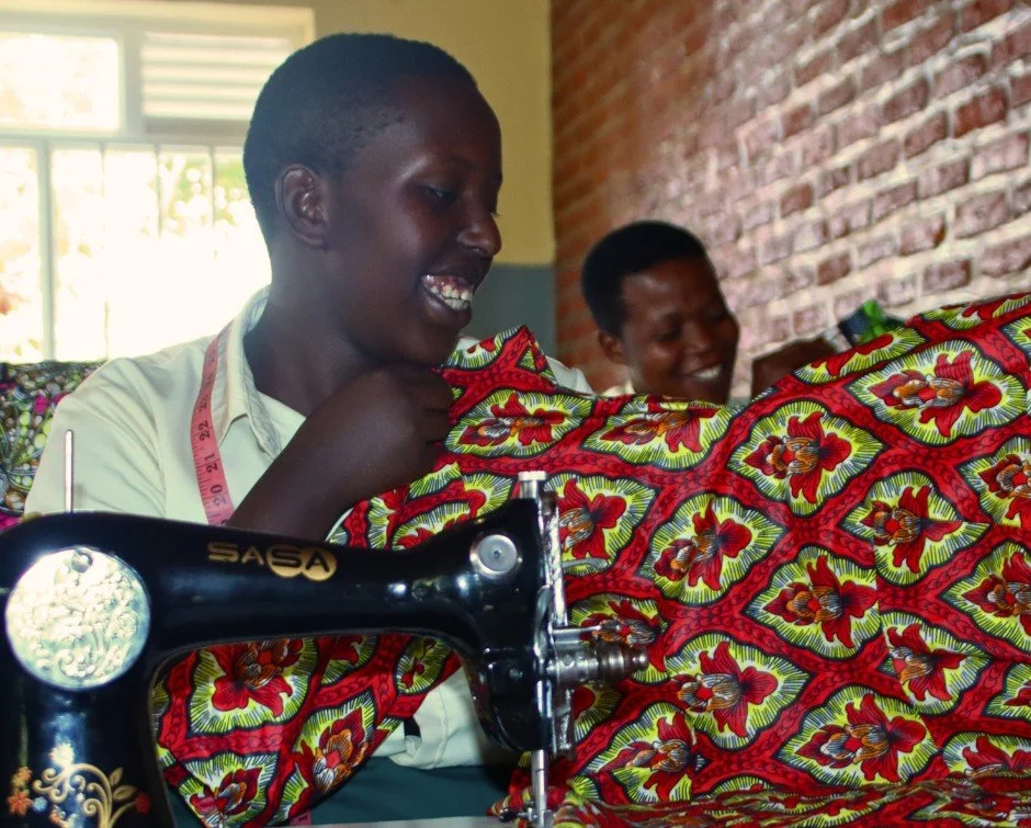 The sewing machine hums.

Kitenge fabric moves steadily through practiced hands.

Women laugh and talk as they work.

It sounds ordinary.

It isn't.

For many participants in this program, moments like these represent income, independence, and hope f