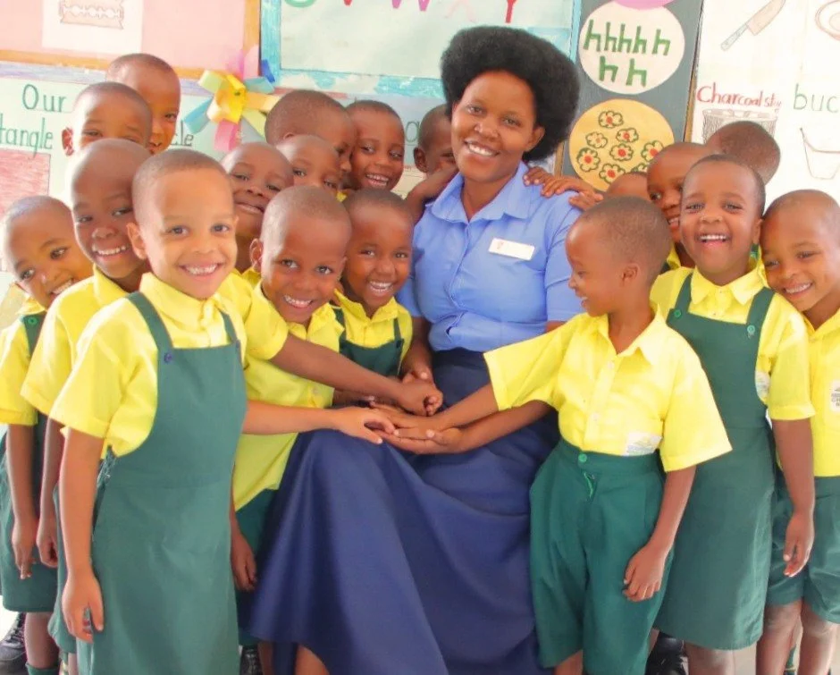 Count the smiles.

Now count how many children are trying to squeeze just a little closer to their teacher, Angelique Uwizeyimana.

This school year has come to an end for Angelique's Early Childhood Development class.

Together they've learned their