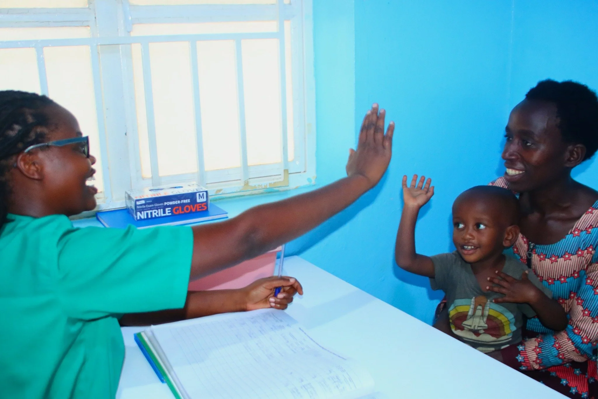 What does it take to make a two-year-old feel safe at a check-up?

Nurse Clenia Nyiramajyambere has an answer: "I smile, talk to the child, and make the child laugh before I examine them."

It worked.

Two-year-old Kelia sat calmly and happ
