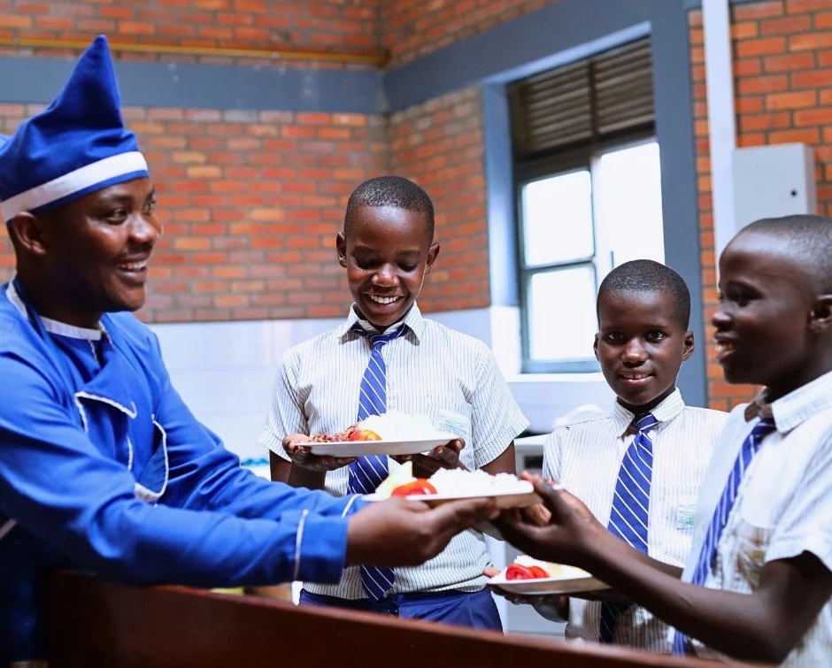 The first meal of a new school year matters.

On the first day of the term, Jean De Dieu Nshimiyimana served lunch to four RCCS Primary students. Jean has spent years working in the RCCS kitchen, and he wanted to make their first meal of the year a l