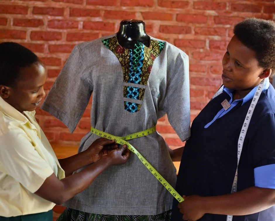 Two weeks ago, Evangeline had never touched a sewing machine.

This week, she was measuring a garment on a mannequin.

Under the guidance of our sewing training teacher, Alice Mujawiyera, she's learning to operate a sewing machine, practice different