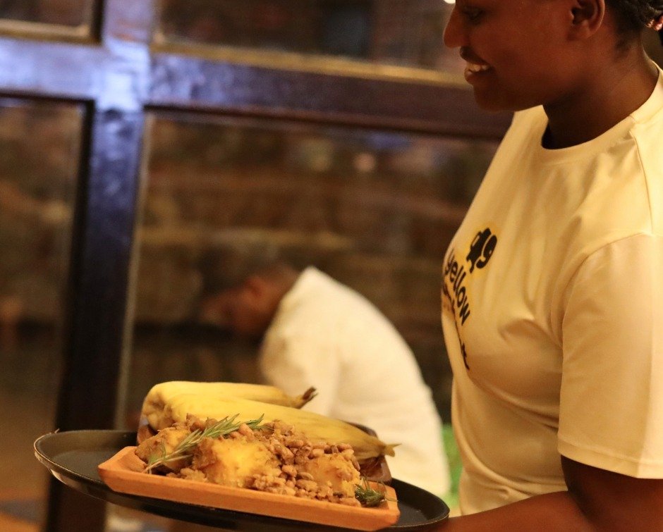 There was something besides coffee on the menu at Yellow Elephant this week.

Head chef Nestor Uwayezu prepared a traditional Rwandan meal of pumpkin, beans, and corn, served on traditional Imbehe plates.

Diane Ishimwe carried it out.

Nestor says h