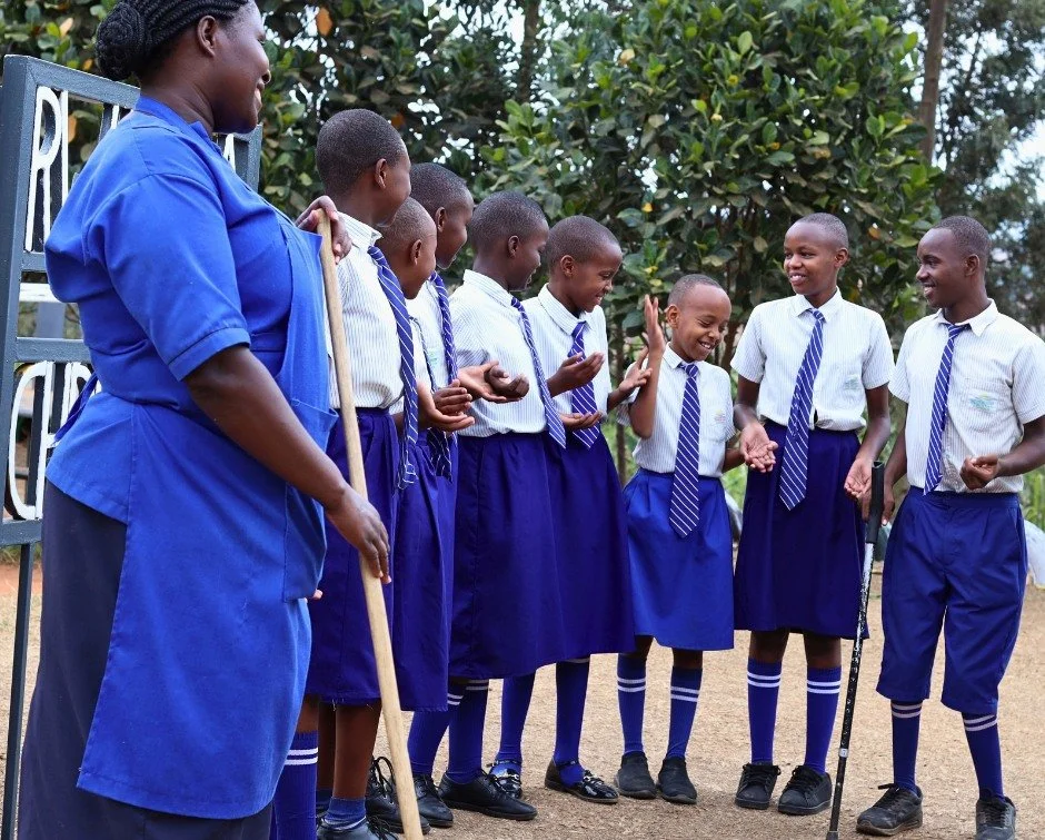 Esperance had her broom in hand as she stopped to watch the students.

She helps keep the RCCS campus clean, and this week she paused by the gate while a group of students laughed their way through a clapping game.

For a moment, she wasn&rsquo;t the