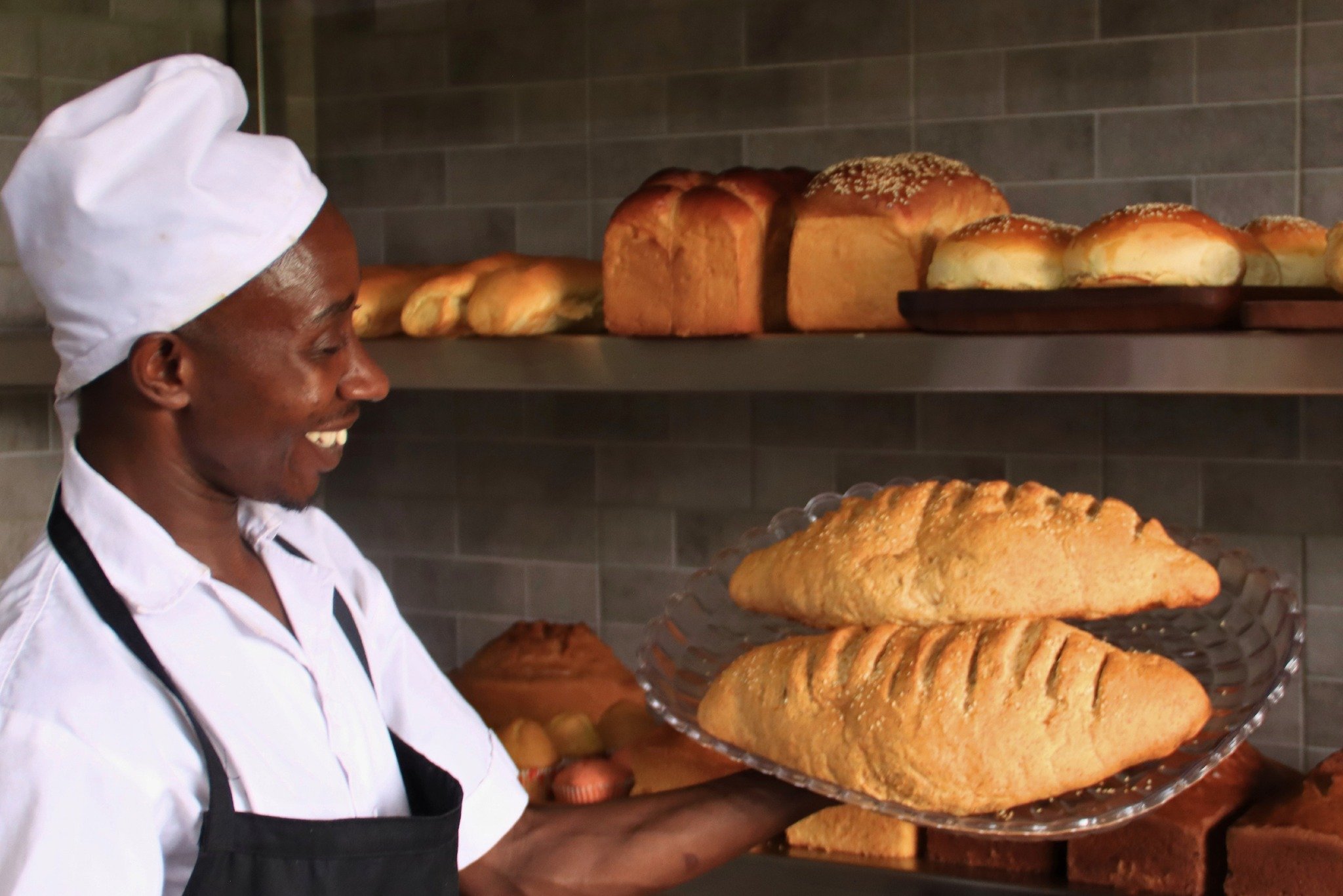 Daniel Ntirenganya has been part of the Yellow Elephant bakery team since the coffee shop opened three months ago.

The team makes brown bread, sandwiches, pain coup&eacute;, doughnuts, and loaves like the ones Daniel is holding here.