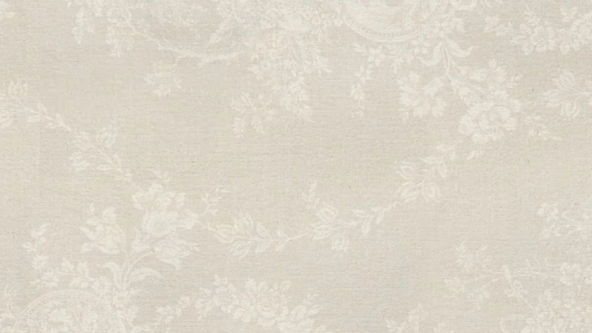 Close-up of beige wallpaper with a subtle floral vine pattern.